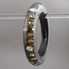 Load image into Gallery viewer, Vintage 1980s Lucite Bangle Bracelet with Iridescent Rhinestones - Clear, Black and Metallic Gold Acrylic Resin - Embedded Aurora Borealis AB Crystal Stones