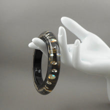Load image into Gallery viewer, Vintage 1980s Lucite Bangle Bracelet with Iridescent Rhinestones - Clear, Black and Metallic Gold Acrylic Resin - Embedded Aurora Borealis AB Crystal Stones