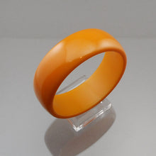 Load image into Gallery viewer, A vintage authentic bakelite plastic bangle bracelet. Opaque butterscotch. Simichrome tested.  Approximately 1&quot; wide x 3&quot; diameter; inside opening diameter is 2 1/2&quot;  37.9 grams  Vintage pre-owned original condition with expected scratches.