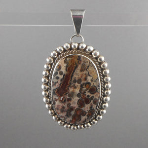 A vintage Mexican leopard jasper and sterling silver pendant. Natural stone, bezel set in an elaborate rope and bead design frame. Hand crafted in Mexico. FREE Shipping to US locations