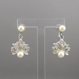 A pair of vintage silver tone, faux pearl and rhinestone dangle earrings. Circa 1960, maker unknown. Screw backs for non pierced ears. Each approximately 5/8" x 1 1/8". Excellent vintage pre-owned condition with all stones in place. FREE Shipping to US locations