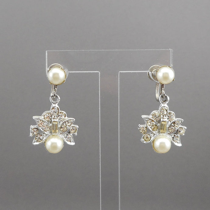 A pair of vintage silver tone, faux pearl and rhinestone dangle earrings. Circa 1960, maker unknown. Screw backs for non pierced ears. Each approximately 5/8