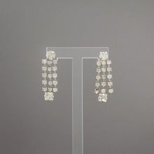 Load image into Gallery viewer, A pair of vintage silver tone and rhinestone dangle earrings. Circa 1950, maker unknown. Screw backs for non pierced ears. Excellent vintage pre-owned condition with all stones in place. FREE Shipping to US locations
