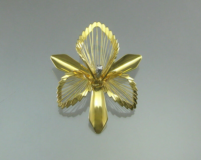 A large scale vintage gold tone and rhinestone flower statement brooch. Signed designer pin by Monet in an orchid design. Excellent vintage pre-owned condition. Barely, if ever, worn. FREE Shipping to US locations