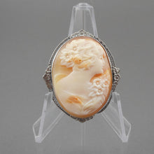 Load image into Gallery viewer, Vintage or antique carved shell cameo brooch in a silver plated setting. Victorian Revival style in a delicate floral and filigree frame.  Approximately 1 3/8&quot; x 1 5/8&quot;.  Vintage pre-owned condition
