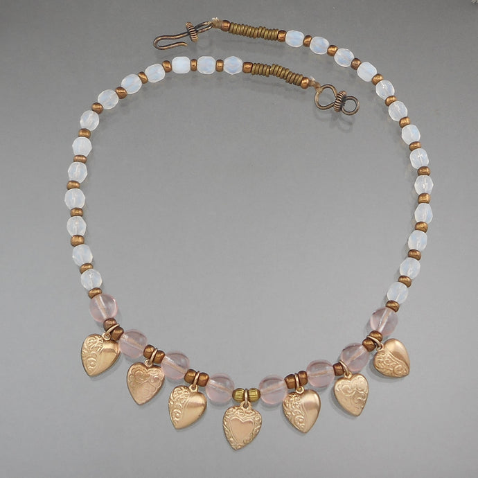 Vintage Handcrafted Collar Necklace. Gold tone heart shaped charms with opalescent and pale pink glass beads. Artist unknown. Approximately 3/4