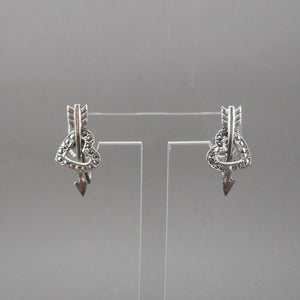 A circa 1950 pair of heart and arrow design earrings. Screw backs for non pierced ears of sterling silver with marcasite stones.  Each approximately 1/2" x 1"  Excellent vintage pre-owned condition with all stones in place. Minor surface scratches and tarnish.  FREE US Shipping via USPS standard shipping