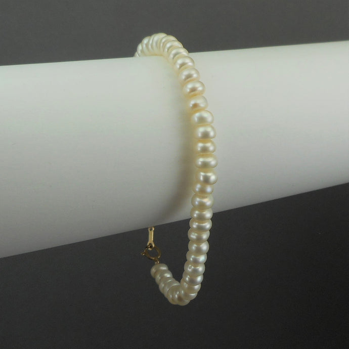 This is a vintage cultured button pearl bracelet with a 10K gold clasp Pearls approximately 5 - 6 mm Bracelet length approximately 7 1/2