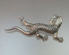 Load image into Gallery viewer, A circa 1980 Lizard Brooch. Southwestern style with a diamond patterned back in sterling silver.  Approximately 1 4/4&quot; x 2 1/2&quot;  Excellent vintage pre-owned condition. Faint and minor surface scratches and a little tarnish.  Refer to the images above to see fine details and further assess the condition of this item.  FREE Shipping via USPS standard shipping to Continental US locations