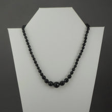 Load image into Gallery viewer, A vintage single strand necklace of French jet (black glass) beads. Collar length, adjustable, with graduated sized faceted round beads.  Approximately 17&quot;  Vintage pre-owned condition commensurate with age and use. Some of the beads have imperfections and small nicks in the surface. FREE Shipping to US locations