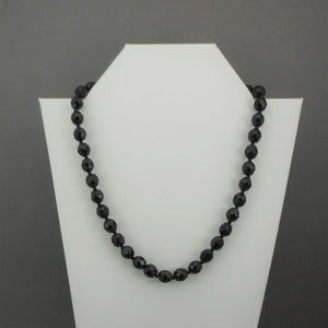 A vintage single strand necklace of French jet (black glass) beads. Collar length with faceted round and seed beads.  Approximately 18 1/2"  Vintage pre-owned condition commensurate with age and use. Some of the beads have imperfections and small nicks in the surface. FREE Shipping to US locations