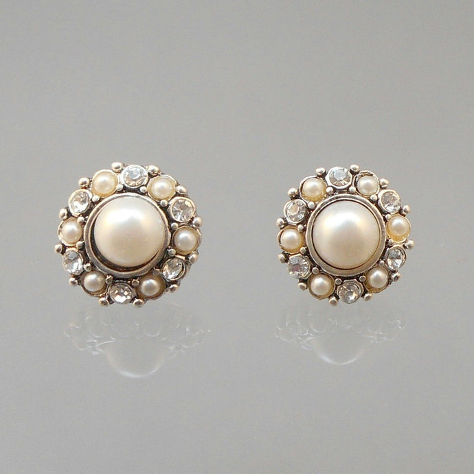 Vintage clip on earrings, silver tone, for pierced ears. Circa 1980 with rhinestones and round faux pearls.  Each approximately 5/8