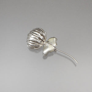 A vintage mid century modern design brooch, unsigned, circa 1960. A silver tone clover flower with a pair of leaves. Approximately 1 3/8" x 3 1/4". Excellent vintage pre-owned condition FREE Shipping to US