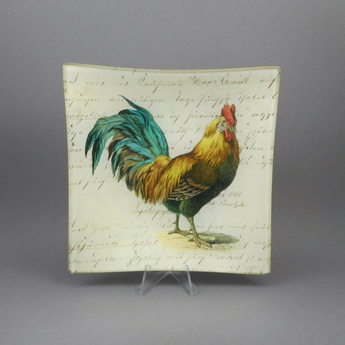 A hand signed decoupaged glass plate. Handmade in the United States by John Derian with a rooster image.  Approximately  5 3/4